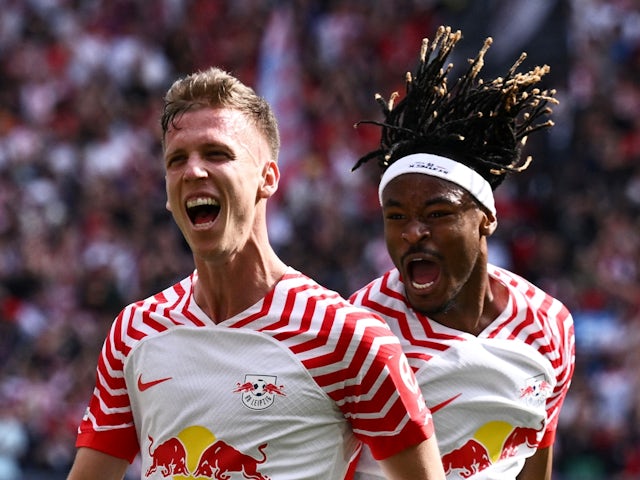 RB Leipzig's Dani Olmo celebrates scoring their first goal with Mohamed Simakan on April 13, 2024