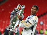 Real Madrid's Jude Bellingham celebrates with the trophy after winning the Champions League