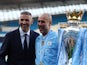 Manchester City manager Pep Guardiola celebrates with chairman Khaldoon Al Mubarak and the trophy after winning the Premier League on May 19, 2024
