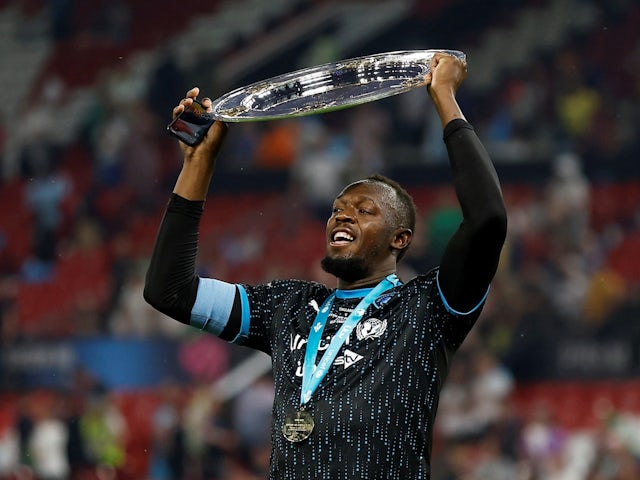 Usain Bolt celebrates with the trophy after winning Soccer Aid 2023 on June 11, 2023