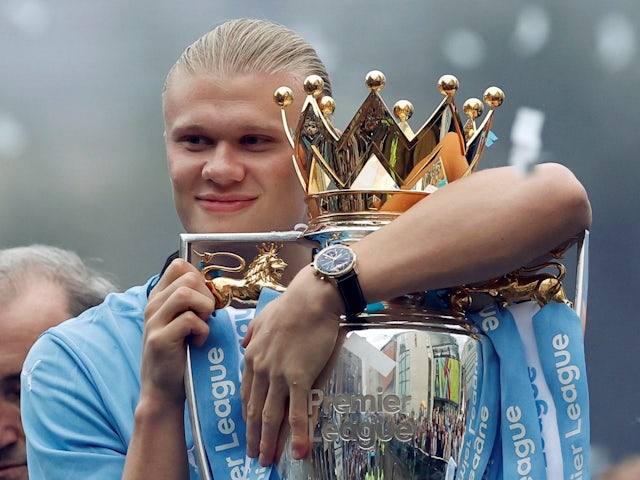 Manchester City's Erling Haaland holds the Premier League trophy on May 26, 2024