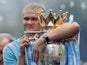 Manchester City's Erling Haaland holds the Premier League trophy on May 26, 2024