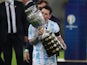 Argentina's Lionel Messi celebrates winning the Copa America as he kisses the trophy on July 10, 2021
