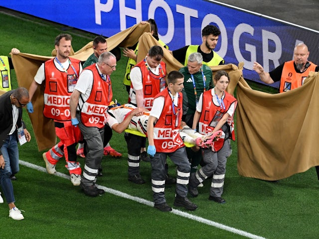 A sheet is put up by stewards as Hungary's Barnabas Varga is stretchered off after sustaining an injury on June 23, 2024