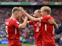 Denmark's Christian Eriksen celebrates scoring their first goal with Rasmus Hojlund and Victor Kristiansen on June 16, 2024