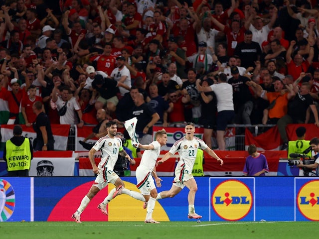  Hungary's Kevin Csoboth celebrates scoring their first goal with Dominik Szoboszlai and Roland Sallai on June 23, 2024