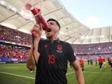 Albania's Mirlind Daku uses a megaphone to shout to supporters after the match on June 19, 2024 [IMAGO]