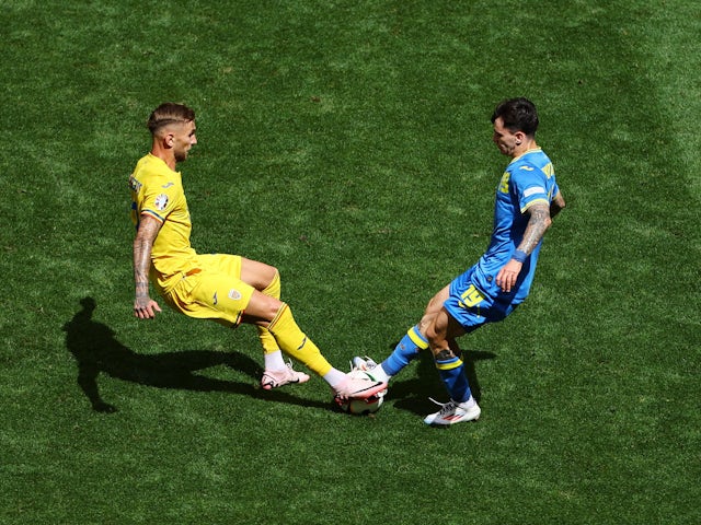 Ukraine's Mykola Shaparenko in action with Romania's Denis Dragus on June 17, 2024