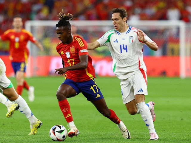 Spain's Nico Williams in action with Italy's Federico Chiesa on June 20, 2024