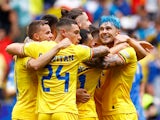 Romania's Bogdan Racovitan, Andrei Ratiu and teammates celebrate after the match on June 17, 2024