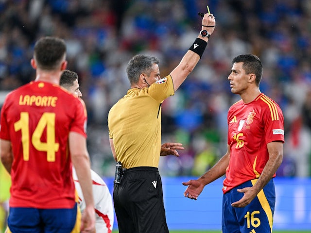 Spain's Rodri is given a yellow card by referee Slavko Vincic in June 2024 [IMAGO]