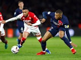 PSG's Kylian Mbappe in action with AS Monaco's Vanderson on November 24, 2023