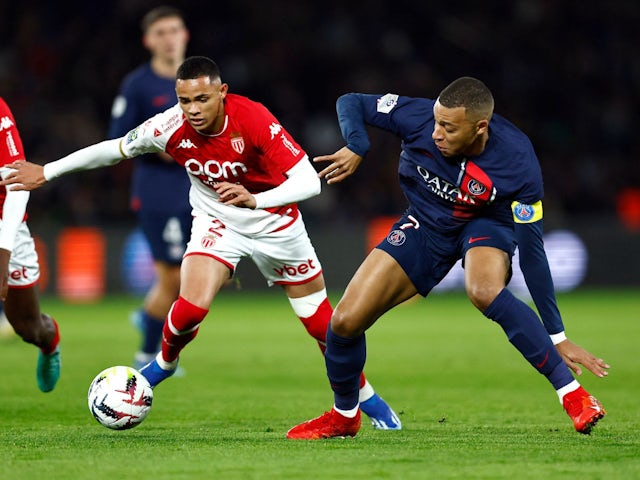 PSG's Kylian Mbappe in action with AS Monaco's Vanderson on November 24, 2023