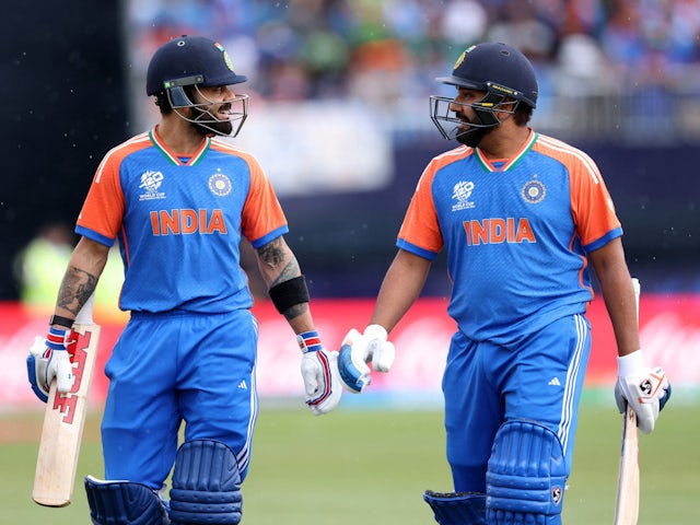 India's Rohit Sharma and Virat Kohli leave the pitch due to rain on June 26, 2024