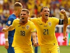 Romania qualify at top spot after draw with Slovakia
