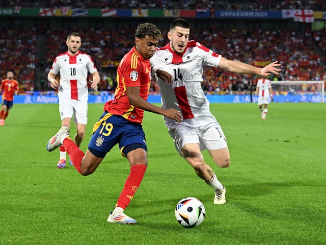Spain's Lamine Yamal in action with Georgia's Luka Lochoshvili on June 30, 2024