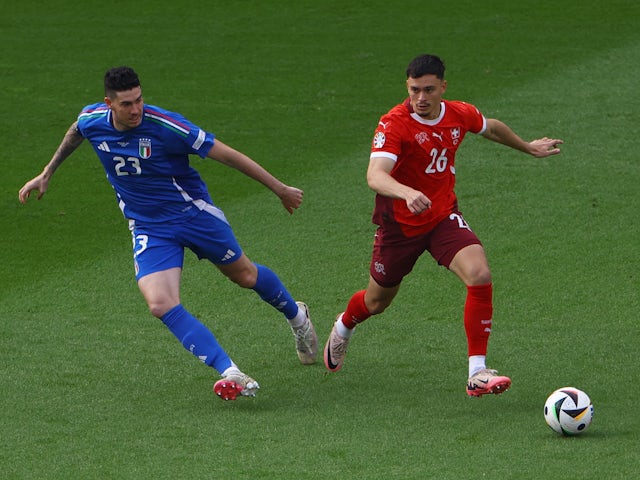 Italy's Alessandro Bastoni in action with Switzerland's Fabian Rieder on June 29, 2024