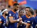 Netherlands' Cody Gakpo celebrates scoring their first goal with Xavi Simons on July 2, 2024