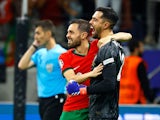 Portugal's Diogo Costa celebrates with Bernardo Silva after winning the penalty shootout on July 1, 2024