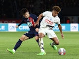 Paris Saint-Germain's Lee Kang-in in action with Rennes' Desire Doue on April 3, 2024