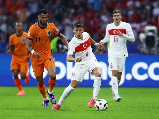 Netherlands' Cody Gakpo in action with Turkey's Arda Guler on July 6, 2024