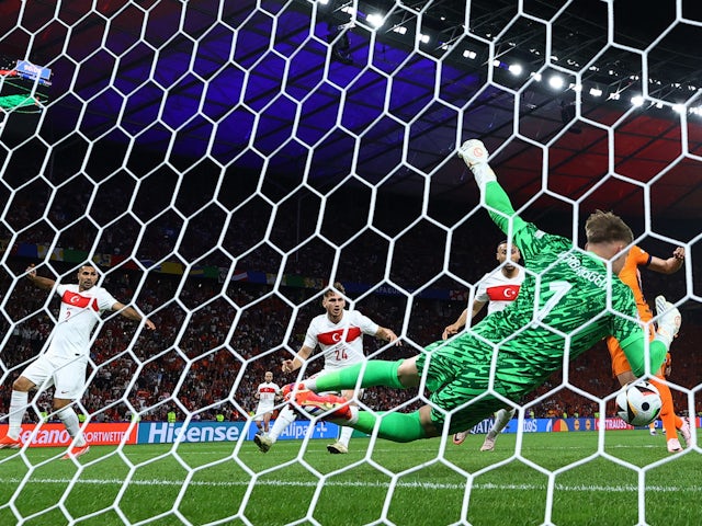 Netherlands' Bart Verbruggen saves from Turkey's Semih Kilicsoy on July 6, 2024