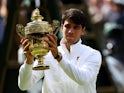 Carlos Alcaraz poses with the trophy after winning the Wimbledon title on July 14, 2024