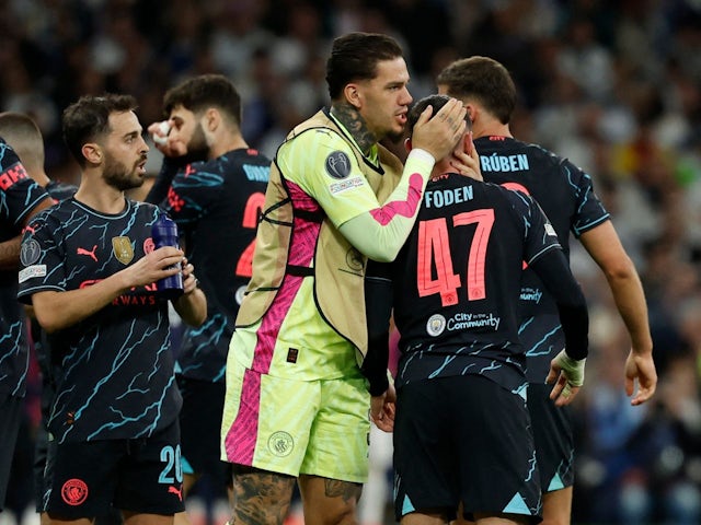 Manchester City's Phil Foden celebrates scoring their second goal with Ederson on April 9, 2024