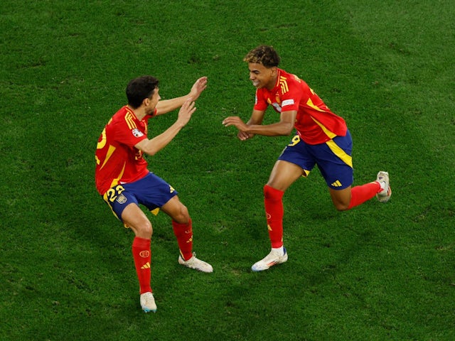 Spain's Lamine Yamal celebrates scoring their first goal with Jesus Navas on July 9, 2024