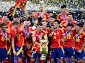 Spain's Alvaro Morata lifts the trophy as he celebrates with teammates after winning Euro 2024 on July 14, 2024