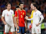 Spain's Sergio Busquets talks to England's Ben Chilwell on October 15, 2018