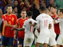 Spain's Paco Alcacer clashes with England's Raheem Sterling on October 15, 2018