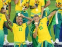 Brazil's Dani Alves and Richarlison celebrate with their gold medals at the Tokyo 2020 Olympics on August 7, 2021
