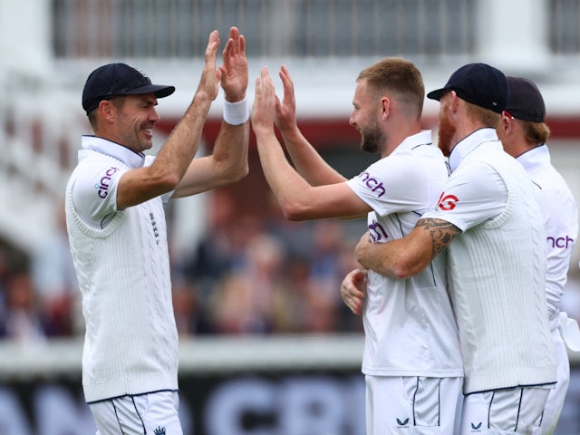 England's Gus Atkinson celebrates with teammate James Anderson after taking a wicket on July 10, 2024 