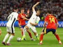 England's Harry Kane in action with Spain's Dani Olmo on July 14, 2024