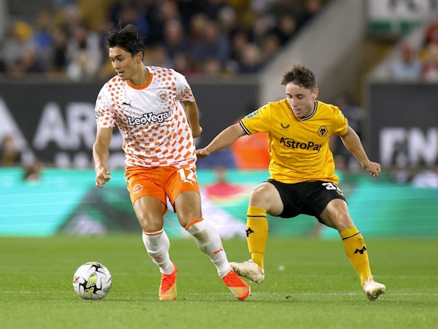 Blackpool's Kenneth Dougall and Wolverhampton Wanderers' Joe Hodge in action in August 2024.