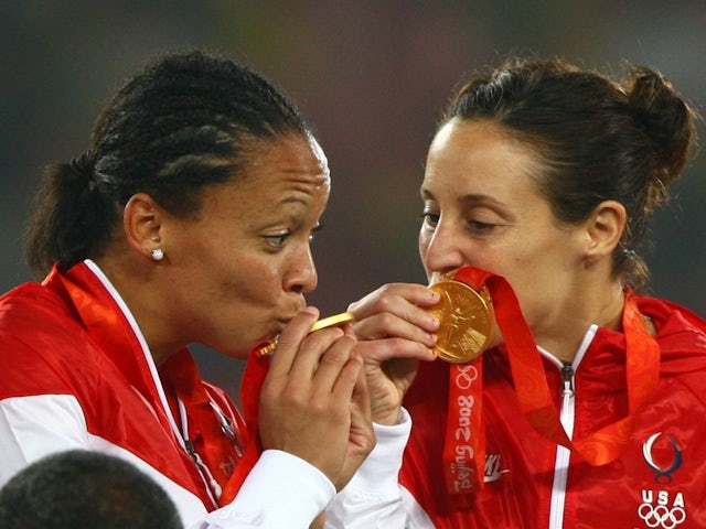 USA Women's football players kiss their gold medals at the Beijing 2008 Olympics on August 21, 2008