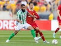 Liverpool's Curtis Jones in action with Real Betis' Nabil Fekir on July 26, 2024