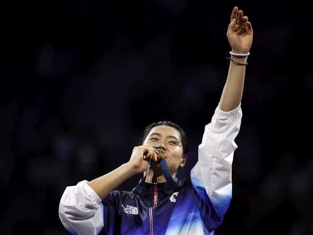 Gold medalist Sanguk Oh of South Korea celebrates with his medal in the Men's Sabre Fencing on July 27, 2024