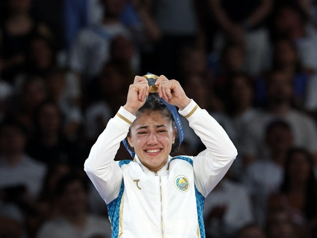 Gold medallist Diyora Keldiyorova of Uzbekistan celebrates on the podium on July 28, 2024