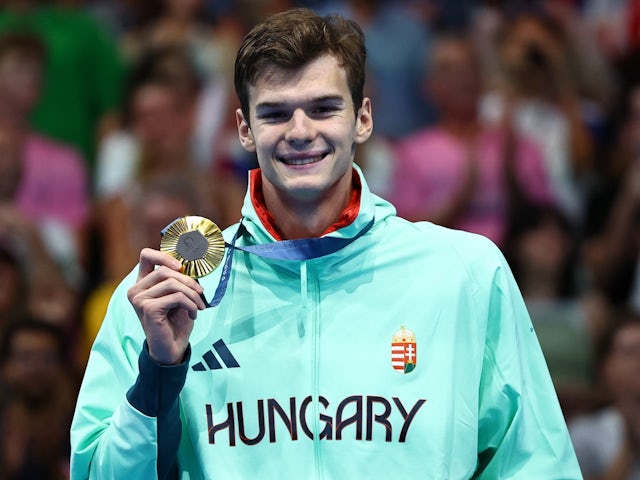 Gold medallist Hubert Kos of Hungary celebrates on the podium after winning on August 1, 2024