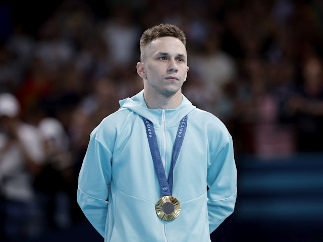 Gold medallist Ivan Litvinovich of AIN stands with his medal on the podium on August 2, 2024