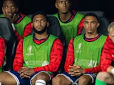 England substitutes Joe Gomez (L) and Liverpool team-mate Trent Alexander-Arnold (R) on the bench during the UEFA Euro 2024 Semi-Final match between Netherlands and England on July 10, 2024