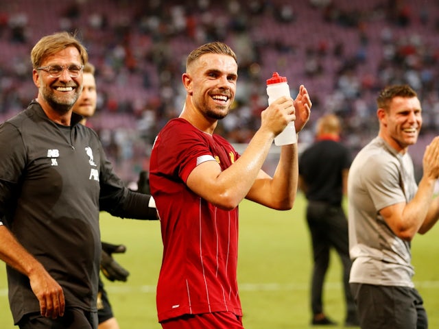 Liverpool manager Jurgen Klopp applauds the fans after the match with Jordan Henderson on July 31, 2019