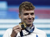 Gold medallist Leon Marchand of France celebrates on July 28, 2024