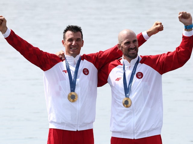 Gold medalists Martin Sinkovic of Croatia and Valent Sinkovic of Croatia celebrate on the podium after winning on August 2, 2024