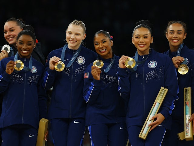 Gold medallists Simone Biles of United States, Jordan Chiles of United States, Jade Carey of United States, Sunisa Lee of United States and Hezly Rivera of United States celebrate with their medals on the podium on July 30, 2024