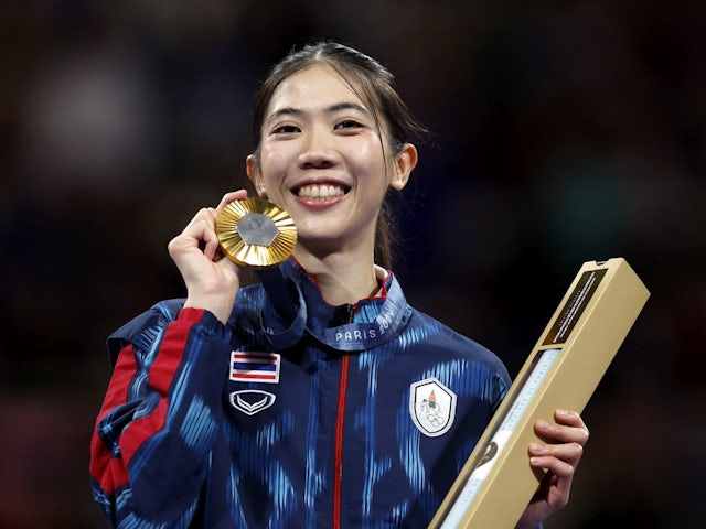 Panipak Wongpattanakit of Thailand celebrates on the podium after winning the Gold medal on August 7, 2024