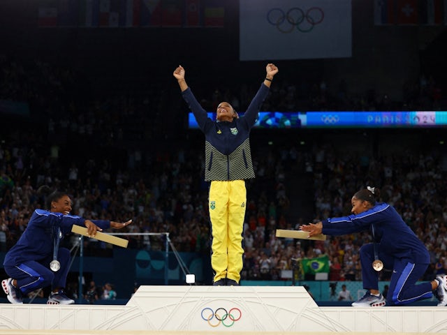 Gold medallist Rebeca Andrade of Brazil celebrates on the podium with silver medallist Simone Biles of United States and bronze medallist Jordan Chiles of United States on August 5, 2024