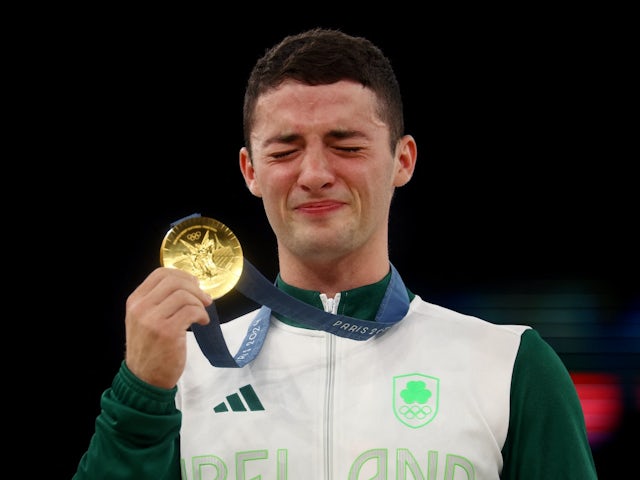 Gold medallist Rhys McClenaghan of Ireland celebrates on the podium on August 3, 2024